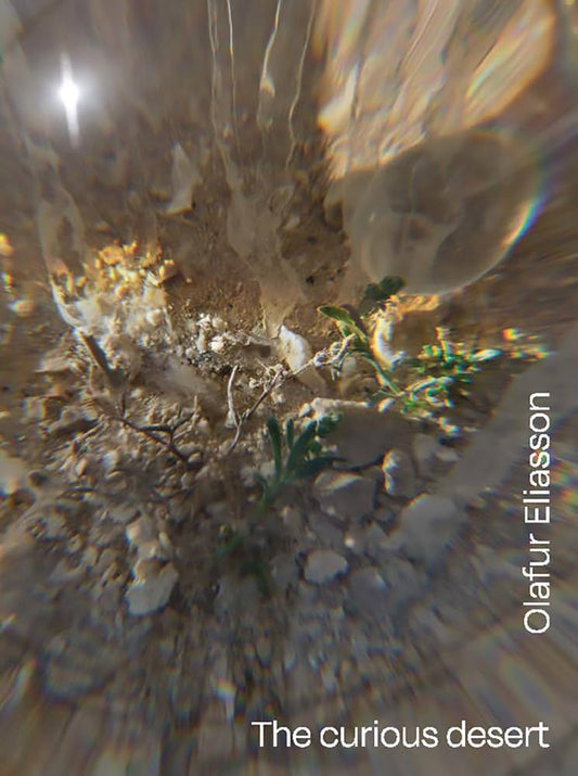 Close-up of desert plants with a blurred background, featuring the text 'Olaefur Eliasson The curious desert'.