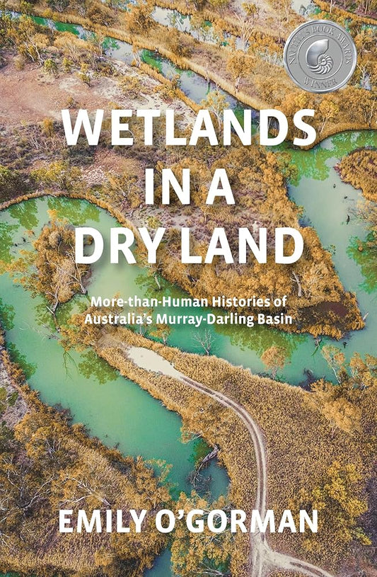 Book cover for 'Wetlands in a Dry Land' featuring a photograph of a dry, flood-affected landscape with text and a logo.