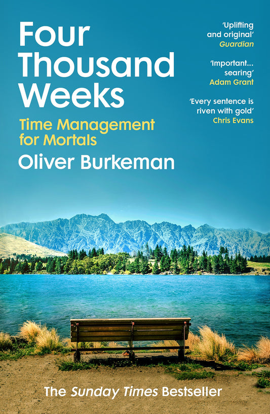 Book cover of 'Four Thousand Weeks' with a bench overlooking a lake and mountains.
