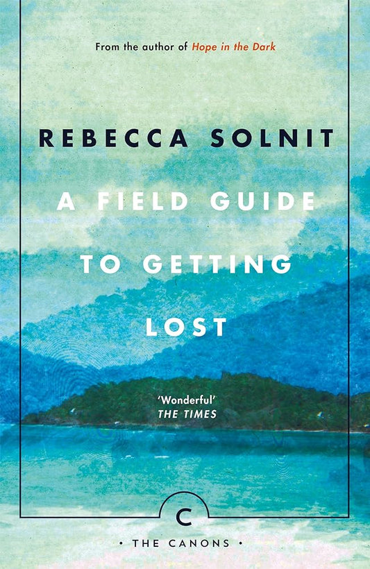 Book cover of "A Field Guide to Getting Lost" by Rebecca Solnit, with an artistic design depicting a hilly island