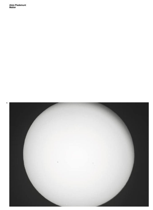 A black and white image of a celestial body, possibly the moon, with a dark background.