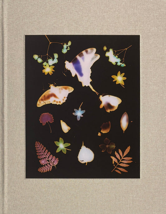 Decorative book cover with pressed flowers and butterflies on a dark background