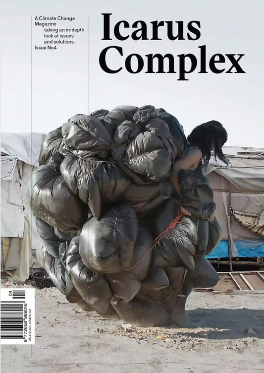 Magazine cover titled 'Icarus Complex' with a large pile of bags on a beach.