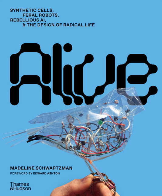Book cover of 'Alive' with a blue background and a transparent mechanical object held by a hand.
