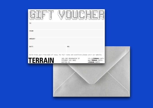 A gift voucher labeled 'GIFT VOUCHER' from TERRAIN, placed on top of a solid blue background.
