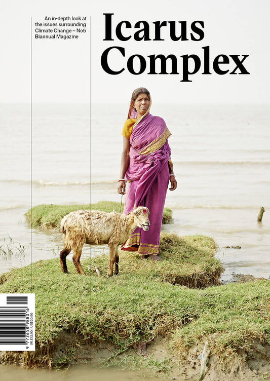 The cover of ICARUS Complex magazine features a woman standing by a sheep on a grassy area, with the title and branding visible. The magazine is packaged in a bag with a clear window displaying the cover and a tagline that reads 'An award-winning environmental magazine'.